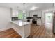Bright kitchen features white cabinets, marble countertops, stainless steel appliances, and stylish backsplash at 138 Shepherd Rd, Mooresville, NC 28115
