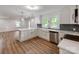 A spacious kitchen with an island and white cabinets boasts stainless steel appliances, and elegant countertops at 138 Shepherd Rd, Mooresville, NC 28115