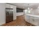 Modern kitchen showcasing stainless steel refrigerator, white cabinets, and hardwood flooring at 138 Shepherd Rd, Mooresville, NC 28115
