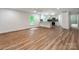 Open-concept living space with modern wood floors, plenty of natural light, and a view of the kitchen and bathroom at 138 Shepherd Rd, Mooresville, NC 28115