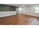 Spacious living area with hardwood floors, complemented by white wainscotting and large windows at 138 Shepherd Rd, Mooresville, NC 28115