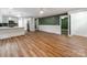Open-concept living space featuring wood floors, a kitchen with modern appliances, and lots of natural light at 138 Shepherd Rd, Mooresville, NC 28115