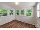 Bright sunroom featuring wood flooring, whitewashed walls, and windows all around, perfect for relaxing at 138 Shepherd Rd, Mooresville, NC 28115