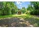 Expansive backyard with mature trees and a wooden shed at 13821 David St, Huntersville, NC 28078