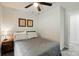 Cozy bedroom featuring a queen-sized bed with gray bedding, side table, and ceiling fan at 13821 David St, Huntersville, NC 28078
