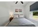 Bright bedroom with ceiling fan, side table, decor, and a window at 13821 David St, Huntersville, NC 28078