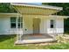 Close-up of a covered front porch with decorative metal supports and the house number clearly visible at 13821 David St, Huntersville, NC 28078