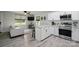 Modern kitchen with island seating, white cabinets, and stainless steel appliances open to the living area at 13821 David St, Huntersville, NC 28078