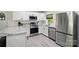 Well-equipped kitchen featuring stainless steel appliances, white subway tile backsplash, and granite countertops at 13821 David St, Huntersville, NC 28078