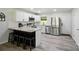 Contemporary kitchen with white cabinetry, granite countertops, stainless steel appliances, and bar seating at 13821 David St, Huntersville, NC 28078