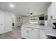 Bright kitchen with white cabinets, granite countertops, stainless steel appliances, and modern flooring at 13821 David St, Huntersville, NC 28078