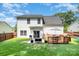 Expansive backyard with lush green grass, deck, grill, patio, and privacy fence, ideal for relaxation and entertainment at 16121 Wrights Ferry Rd, Charlotte, NC 28278