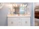 A well-lit bathroom with double vanity sinks, a large mirror, and modern fixtures at 16121 Wrights Ferry Rd, Charlotte, NC 28278
