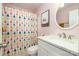 Bathroom featuring white vanity, shower with pattern curtain, and a pink painted wall at 16121 Wrights Ferry Rd, Charlotte, NC 28278
