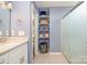 Bathroom with stylish gray shelving, white vanity and a shower with sliding glass doors at 16121 Wrights Ferry Rd, Charlotte, NC 28278