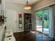 Bright dining area with sliding glass doors, a dark wood floor, and bar stools at 16121 Wrights Ferry Rd, Charlotte, NC 28278
