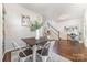 Dining room with hardwood floors, square table, and staircase in background at 16121 Wrights Ferry Rd, Charlotte, NC 28278