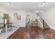 Open-concept dining area featuring hardwood floors and staircase with white railing at 16121 Wrights Ferry Rd, Charlotte, NC 28278