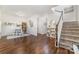 Hardwood floors featuring a staircase with white railing, decor and dining table at 16121 Wrights Ferry Rd, Charlotte, NC 28278