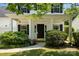 Welcoming front porch with manicured landscaping, covered entrance, and black door with gold hardware at 16121 Wrights Ferry Rd, Charlotte, NC 28278