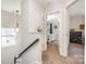 Upstairs hallway featuring a window and an open bedroom at 16121 Wrights Ferry Rd, Charlotte, NC 28278