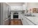 Updated kitchen with stainless steel appliances, granite countertops, white cabinets, and hardwood floors at 16121 Wrights Ferry Rd, Charlotte, NC 28278
