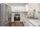 Bright kitchen with stainless steel appliances, white cabinets, and tile flooring at 16121 Wrights Ferry Rd, Charlotte, NC 28278