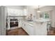 Bright kitchen with stainless steel appliances, white cabinets and bar top seating at 16121 Wrights Ferry Rd, Charlotte, NC 28278