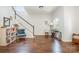 Bright living room with hardwood floors, a staircase, and a large window with natural light at 16121 Wrights Ferry Rd, Charlotte, NC 28278