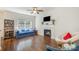 Cozy living room with hardwood floors, a fireplace, and a comfortable blue sofa at 16121 Wrights Ferry Rd, Charlotte, NC 28278