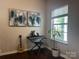 Cozy living room featuring hardwood floors, natural light, keyboard, and a guitar at 16121 Wrights Ferry Rd, Charlotte, NC 28278