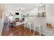 Open-concept living room with hardwood floors, fireplace, bar seating and modern decor at 16121 Wrights Ferry Rd, Charlotte, NC 28278