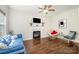 Bright living room with hardwood floors, a fireplace, and a comfortable blue sofa at 16121 Wrights Ferry Rd, Charlotte, NC 28278