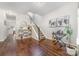 Hardwood floors featuring a staircase with white railing, piano and decor at 16121 Wrights Ferry Rd, Charlotte, NC 28278