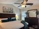 Tranquil main bedroom with a ceiling fan, painting, and warm decor at 16121 Wrights Ferry Rd, Charlotte, NC 28278