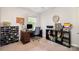 Home office space with a desk, shelves, comfortable chair, and natural light from a large window at 16121 Wrights Ferry Rd, Charlotte, NC 28278