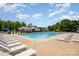 Large community swimming pool with lounge chairs, umbrellas, and a clubhouse, perfect for relaxing and socializing at 16121 Wrights Ferry Rd, Charlotte, NC 28278