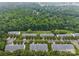 Aerial view showcasing a neighborhood with tree-lined streets and lush green surroundings at 1647 Backcreek Ln, Gastonia, NC 28054