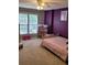A colorful bedroom featuring bright purple walls, toys, and two large windows at 1647 Backcreek Ln, Gastonia, NC 28054