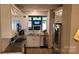 Well-lit kitchen with granite countertops, stainless steel appliances, white cabinets, and a view to a living space at 1647 Backcreek Ln, Gastonia, NC 28054