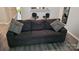 Comfortable seating with a gray couch and zebra print pillows in the living room at 1647 Backcreek Ln, Gastonia, NC 28054