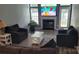 Open living room with dark gray seating, a fireplace, and large windows at 1647 Backcreek Ln, Gastonia, NC 28054