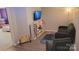 Living room with TV, furniture, games and decor, and open doorway to bedroom at 1647 Backcreek Ln, Gastonia, NC 28054