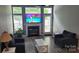 Cozy living room with a fireplace and large windows for natural light at 1647 Backcreek Ln, Gastonia, NC 28054