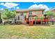 A spacious backyard with a red deck, perfect for outdoor entertaining and relaxation, surrounded by lush greenery at 16714 Hammock Creek Pl, Charlotte, NC 28278