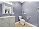 Bathroom with gray vanity, grab bars, and modern fixtures at 16714 Hammock Creek Pl, Charlotte, NC 28278
