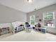 This bedroom features white trim, neutral walls, and a crib for your baby at 16714 Hammock Creek Pl, Charlotte, NC 28278