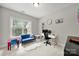 Bright bedroom featuring a large window, a desk, and a cozy loveseat at 16714 Hammock Creek Pl, Charlotte, NC 28278