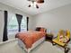 Cozy bedroom with a ceiling fan, large window, and neutral decor at 16714 Hammock Creek Pl, Charlotte, NC 28278