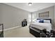 Comfortable bedroom featuring neutral walls, soft carpet, a bed with storage, and bright, natural lighting at 16714 Hammock Creek Pl, Charlotte, NC 28278